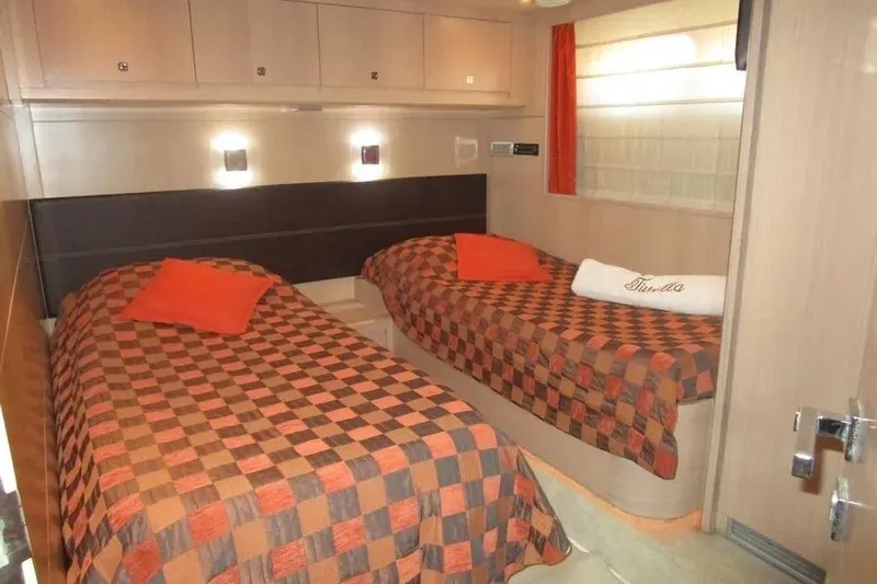 Tivella Yacht Photos Pics Luxurious twin cabin interior on 2009 VZ 68 FLY yacht with checkered bedding.
