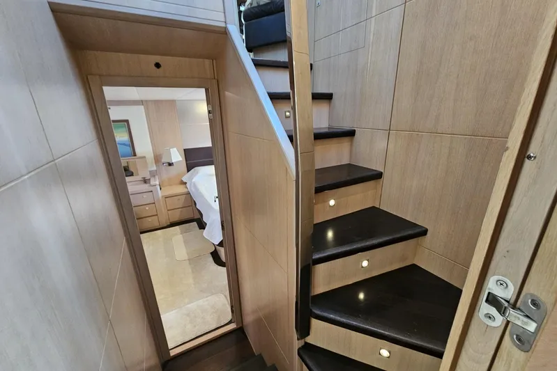 Tivella Yacht Photos Pics Interior of 2009 VZ 68 FLY yacht, featuring wooden stairs and a cozy bedroom.