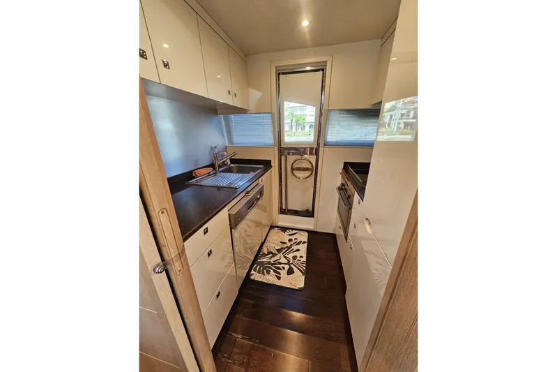 Tivella Yacht Photos Pics Modern kitchen interior on 2009 VZ 68 FLY yacht with sleek cabinetry and appliances.