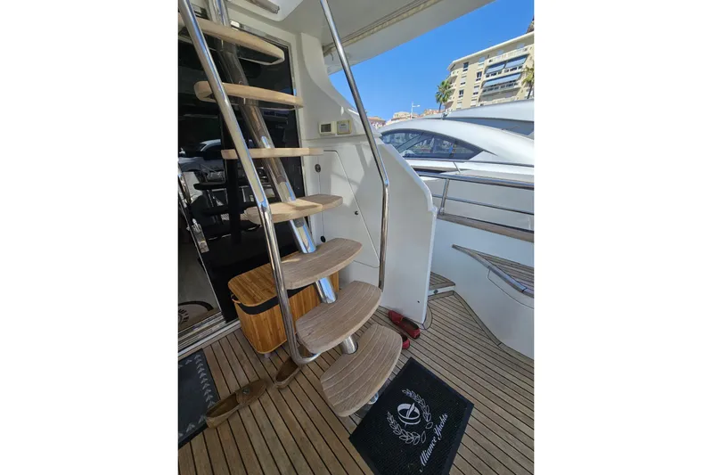 Tivella Yacht Photos Pics Staircase on 2009 VZ 68 FLY yacht with wooden steps and sleek design.