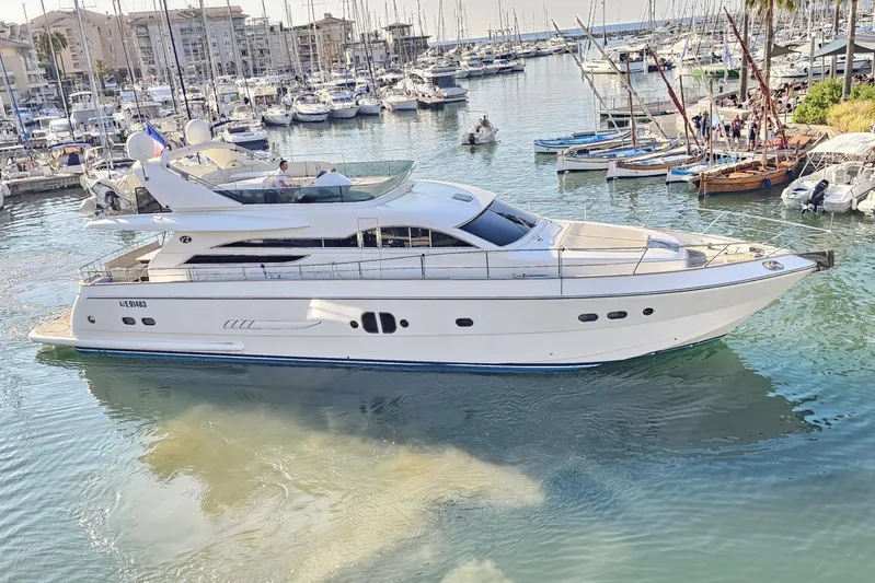 Tivella Yacht Photos Pics Luxurious 2009 VZ 68 FLY yacht docked in a bustling marina.