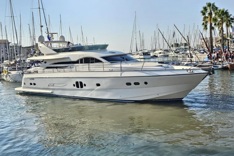 Tivella Yacht Photos Pics Luxurious 2009 VZ 68 FLY yacht docked in a bustling marina.