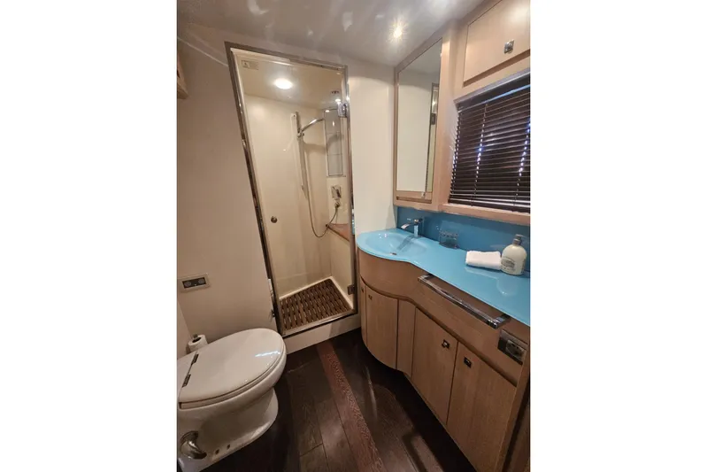 Tivella Yacht Photos Pics Luxurious bathroom in 2009 VZ 68 FLY yacht with modern fixtures and wooden accents.