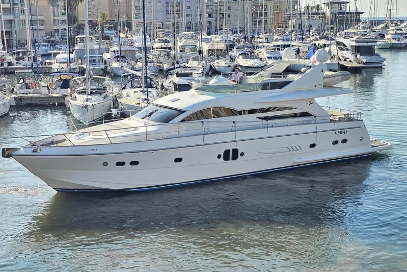 Tivella Yacht Photos Pics Luxury VZ 68 FLY yacht from 2009 docked in a bustling marina.