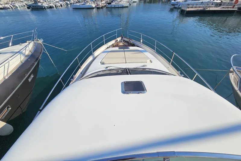 Tivella Yacht Photos Pics 2009 VZ 68 FLY yacht docked in a marina, surrounded by other boats.