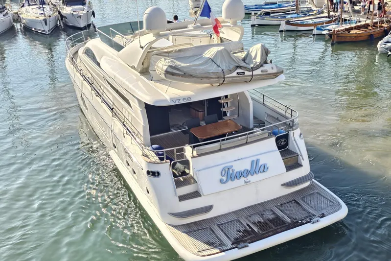 Tivella Yacht Photos Pics Luxury yacht VZ 68 FLY 2009 docked in a marina, rear view.