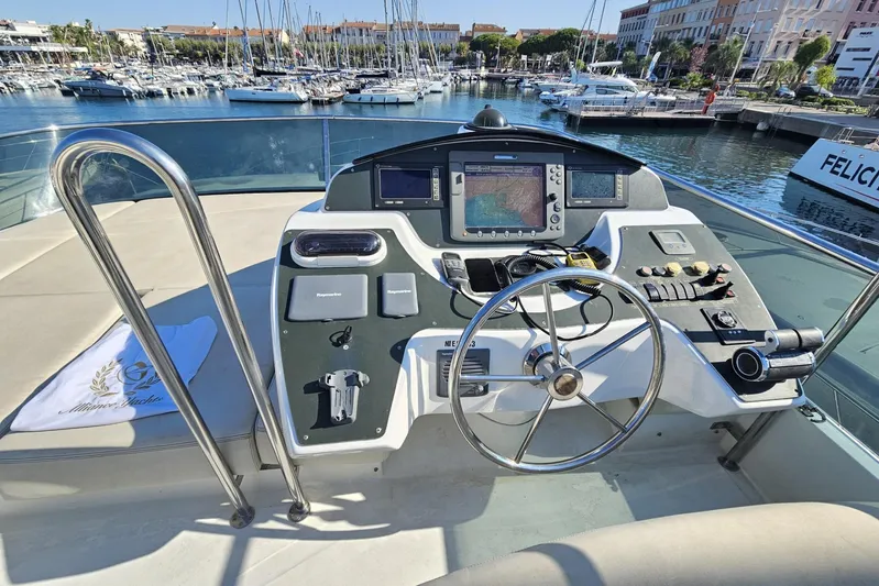 Tivella Yacht Photos Pics Helm of 2009 VZ 68 FLY yacht with navigation equipment, docked in marina.