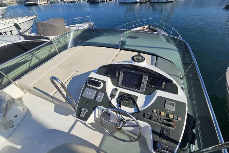 Tivella Yacht Photos Pics Flybridge of 2009 VZ 68 FLY yacht with navigation controls, docked in marina.