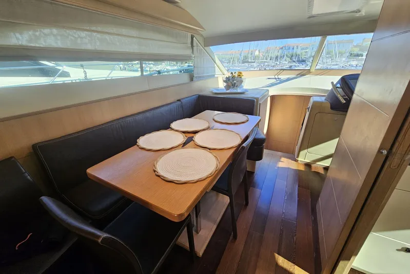Tivella Yacht Photos Pics Luxurious interior of 2009 VZ 68 FLY yacht with dining area and panoramic windows.
