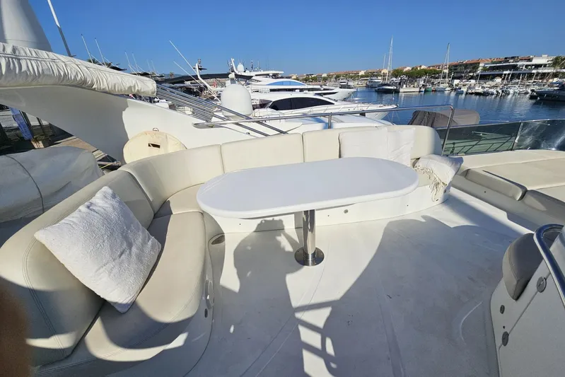 Tivella Yacht Photos Pics Luxurious seating area on 2009 VZ 68 FLY yacht, docked in a marina.