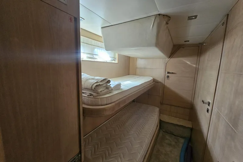 Tivella Yacht Photos Pics Interior cabin of 2009 VZ 68 FLY yacht with bunk beds and wooden finish.