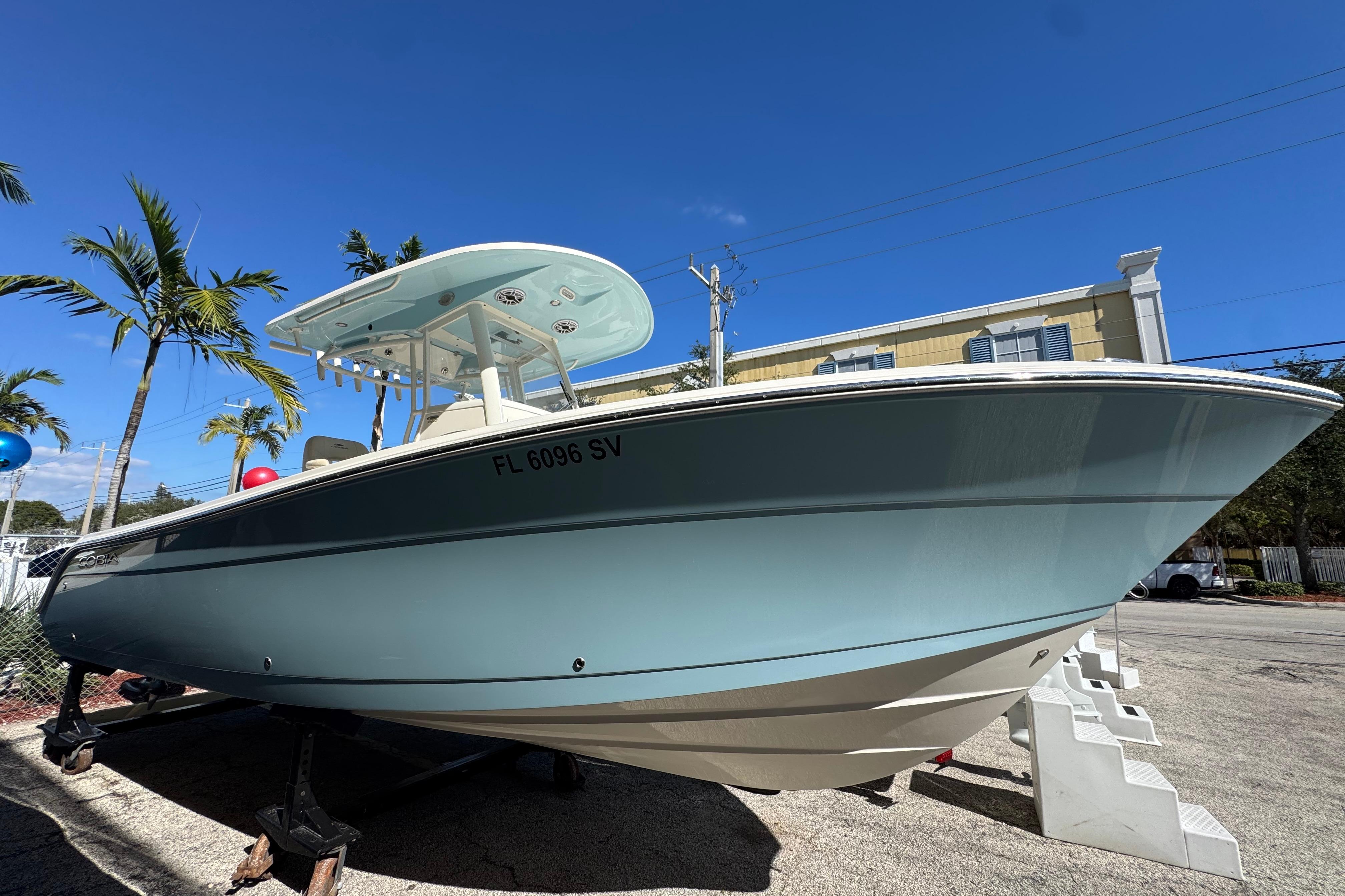 2021 Cobia 262 Center Console boat displayed outdoors under clear blue sky.