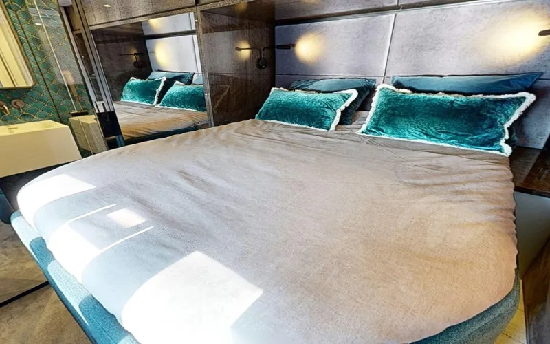 Catallaxi Yacht Photos Pics Luxurious bedroom interior of 2024 Sunreef 60 Sail yacht with plush bedding.