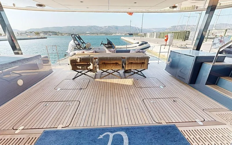 Catallaxi Yacht Photos Pics Luxurious Sunreef 60 Sail yacht deck with seating, overlooking serene waters, 2024 model.