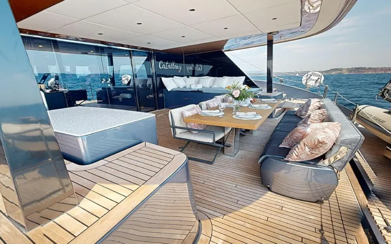 Catallaxi Yacht Photos Pics Luxurious deck of 2024 Sunreef 60 Sail yacht with elegant seating and dining area.
