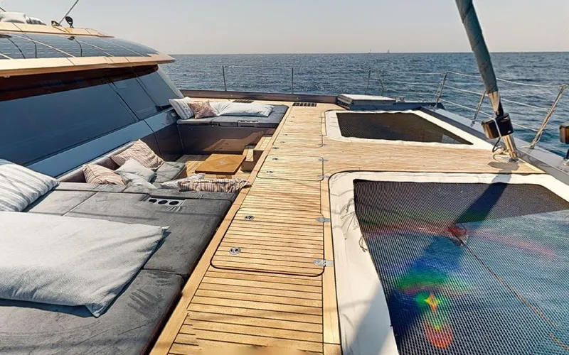 Catallaxi Yacht Photos Pics Luxurious 2024 Sunreef 60 Sail yacht deck with comfortable seating and ocean view.