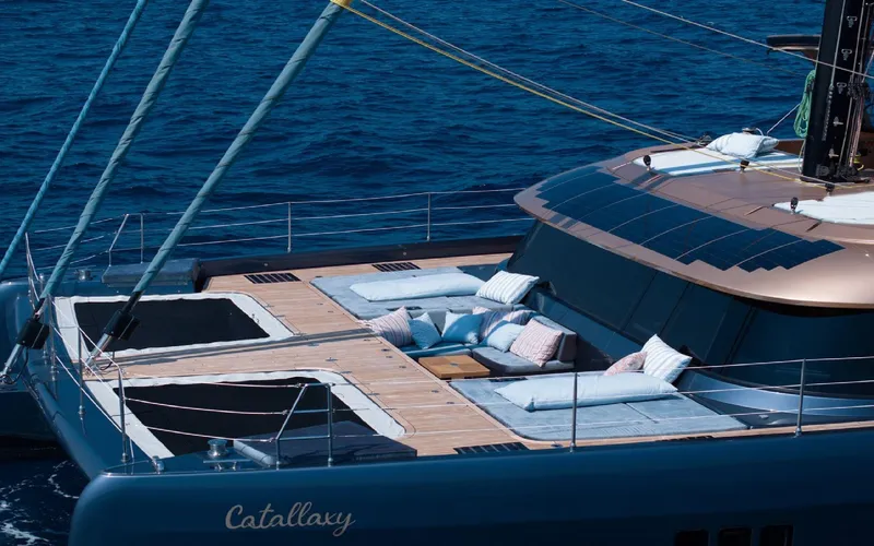 Catallaxi Yacht Photos Pics Luxurious 2024 Sunreef 60 Sail yacht with spacious deck and comfortable lounging area.