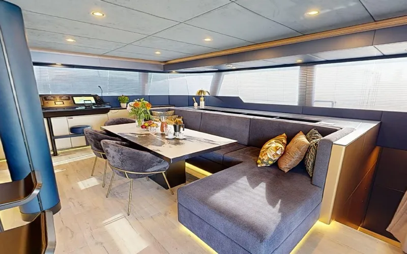 Catallaxi Yacht Photos Pics Luxurious interior of 2024 Sunreef 60 Sail yacht with modern dining area.