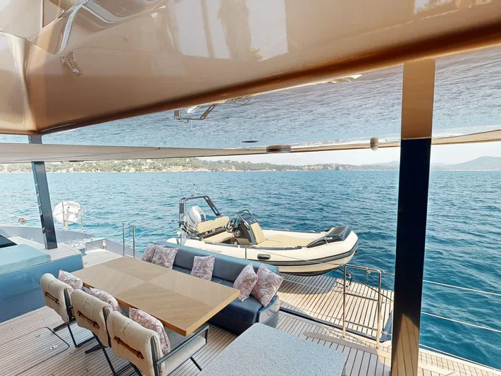 Catallaxi Yacht Photos Pics Luxurious Sunreef 60 Sail yacht deck with dining area, overlooking serene ocean view, 2024 model.