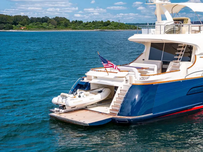 Cetacea Yacht Photos Pics 2008 Mochi Craft Dolphin yacht with tender, anchored in scenic waters.