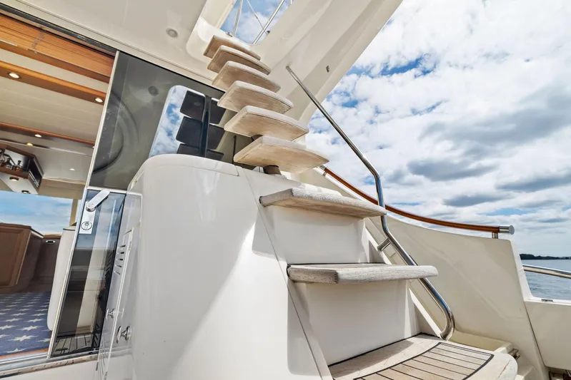 Cetacea Yacht Photos Pics Staircase on 2008 Mochi Craft Dolphin yacht under a partly cloudy sky.