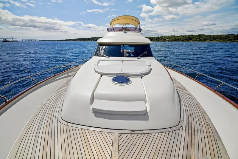 Cetacea Yacht Photos Pics 2008 Mochi Craft Dolphin yacht on open sea, wooden deck, clear sky.