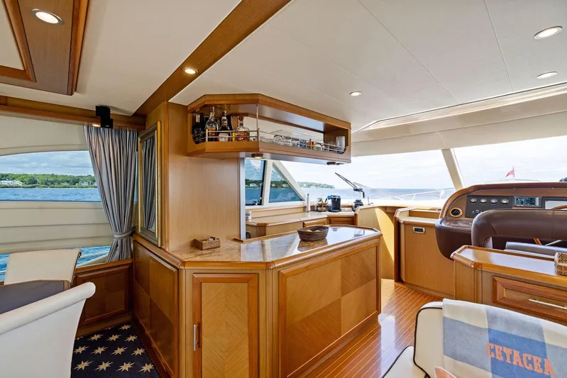 Cetacea Yacht Photos Pics Luxurious interior of 2008 Mochi Craft Dolphin yacht with elegant wood finishes and panoramic windows.
