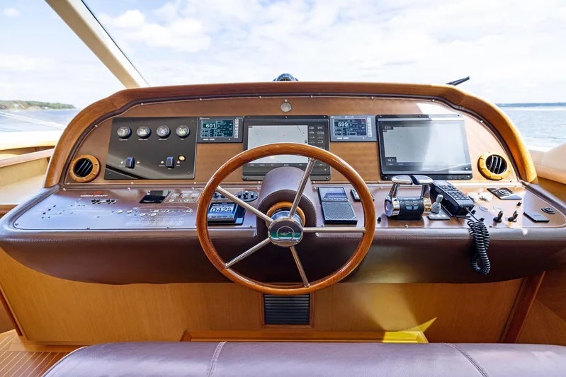 Cetacea Yacht Photos Pics 2008 Mochi Craft Dolphin yacht helm with wooden steering wheel and modern navigation instruments.