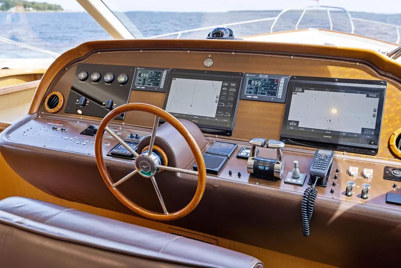 Cetacea Yacht Photos Pics 2008 Mochi Craft Dolphin yacht dashboard with navigation screens and steering wheel.