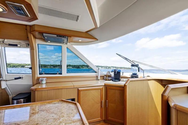 Cetacea Yacht Photos Pics Interior of 2008 Mochi Craft Dolphin yacht with wooden cabinetry and ocean view.