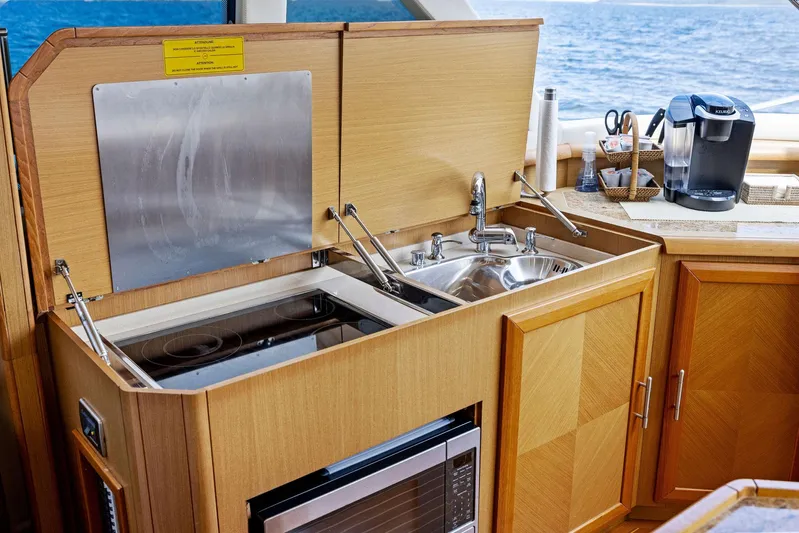Cetacea Yacht Photos Pics 2008 Mochi Craft Dolphin yacht kitchen with sink, stove, and microwave.