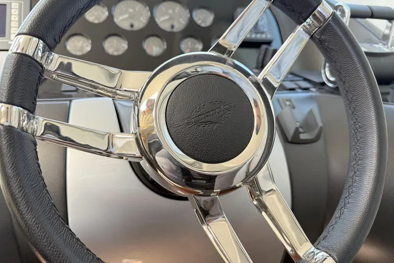 M/y Titan Yacht Photos Pics Steering wheel of a 2011 Sunseeker Predator 74 yacht, featuring chrome and leather details.