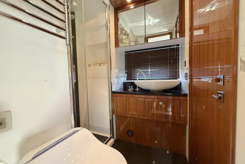 M/y Titan Yacht Photos Pics Luxurious bathroom in 2011 Sunseeker Predator 74 yacht with modern fixtures and wood accents.