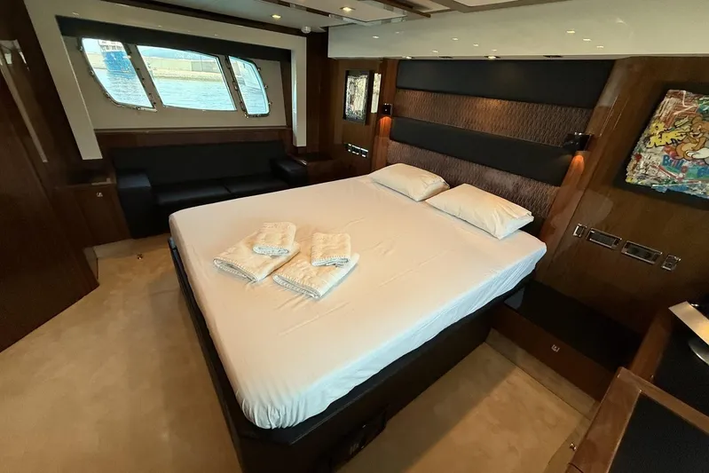 M/y Titan Yacht Photos Pics Luxurious bedroom interior of 2011 Sunseeker Predator 74 yacht with elegant furnishings.