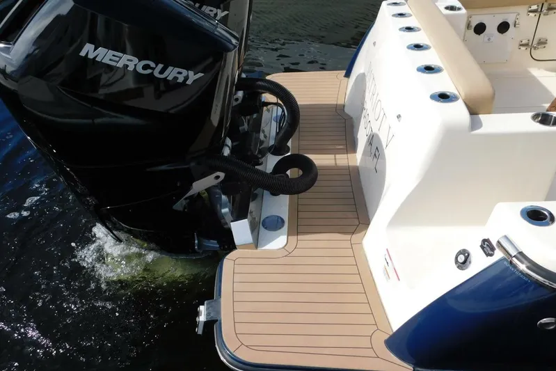  Yacht Photos Pics 2024 Scout 330 LXF boat with Mercury outboard engine on water.