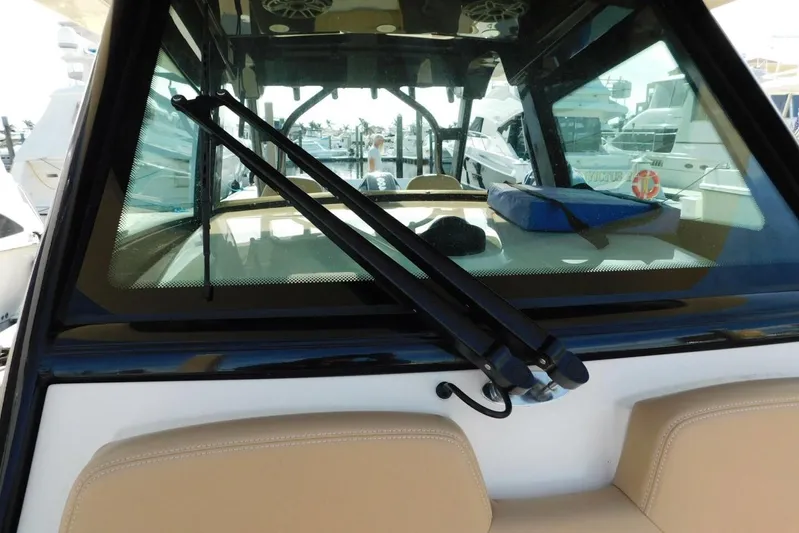  Yacht Photos Pics 2024 Scout 330 LXF boat windshield with wipers, docked at marina.