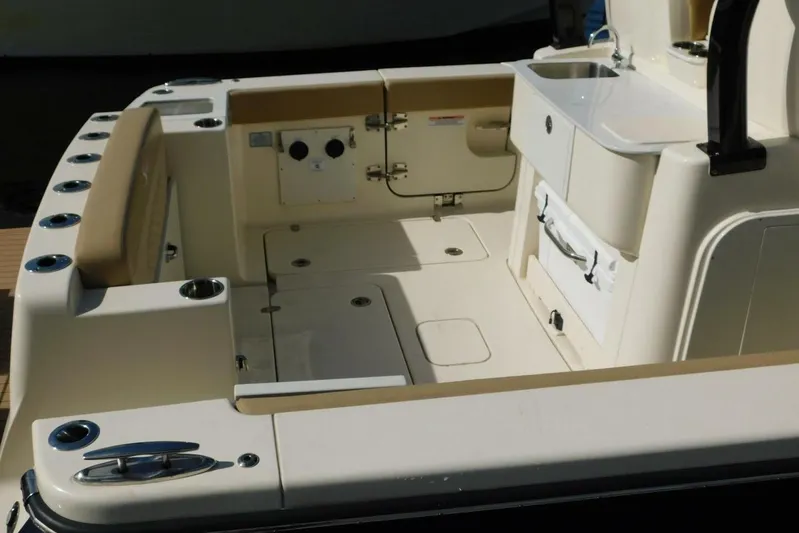  Yacht Photos Pics 2024 Scout 330 LXF boat interior with seating and sink area.