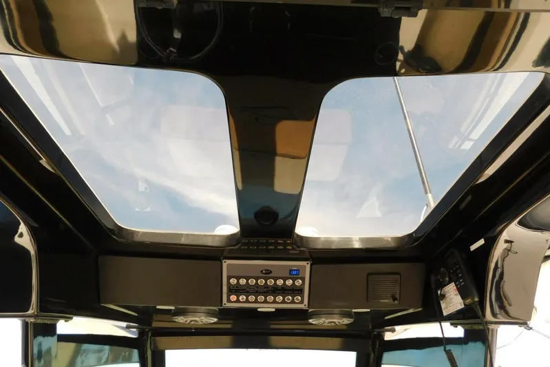  Yacht Photos Pics 2024 Scout 330 LXF boat interior with panoramic sunroof and control panel.