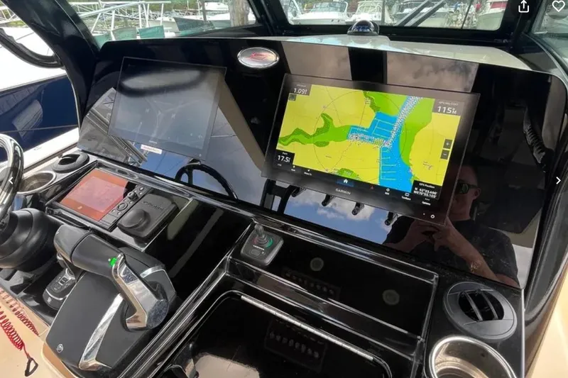  Yacht Photos Pics 2024 Scout 330 LXF boat dashboard with navigation screens and controls.