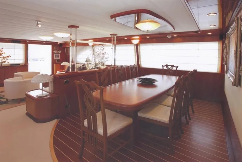  Yacht Photos Pics Luxurious dining area on a 2001 Castagnola 30 mt yacht with elegant wooden furnishings.