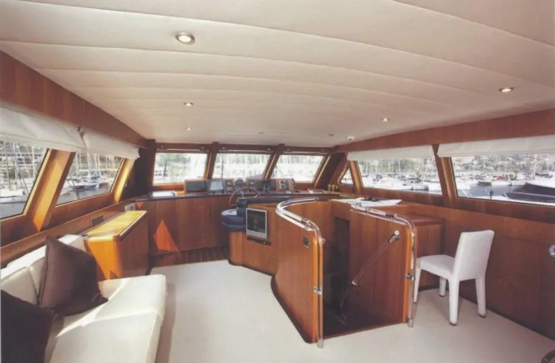  Yacht Photos Pics Luxurious interior of 2001 Castagnola 30 mt yacht with elegant wood finishes and seating.