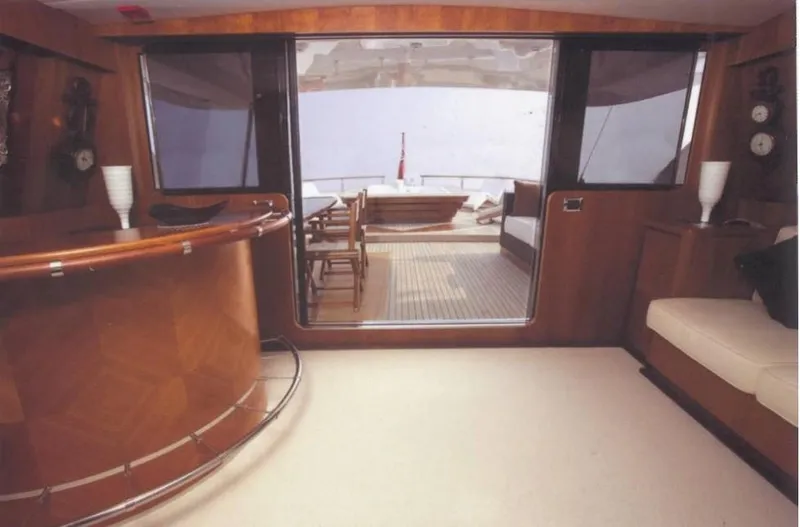  Yacht Photos Pics Luxurious interior of 2001 Castagnola 30 mt yacht with elegant wood finishes and seating.