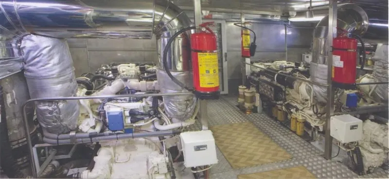  Yacht Photos Pics Engine room of 2001 Castagnola 30 mt yacht with machinery and fire extinguishers.