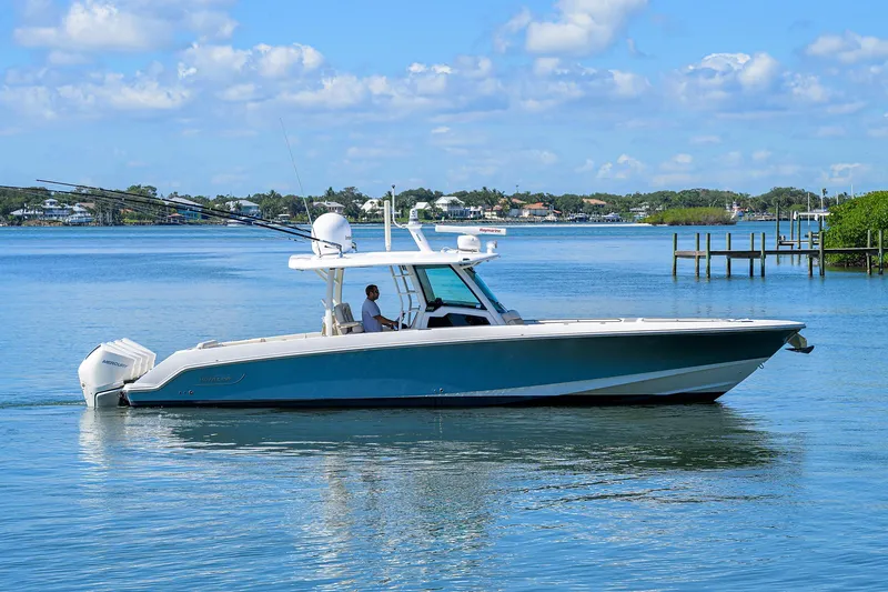 Who's Sippin Yacht Photos Pics 2021 Boston Whaler 380 Outrage boat cruising on calm water under a blue sky.