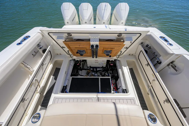 Who's Sippin Yacht Photos Pics 2021 Boston Whaler 380 Outrage boat interior with open storage compartments and four engines.