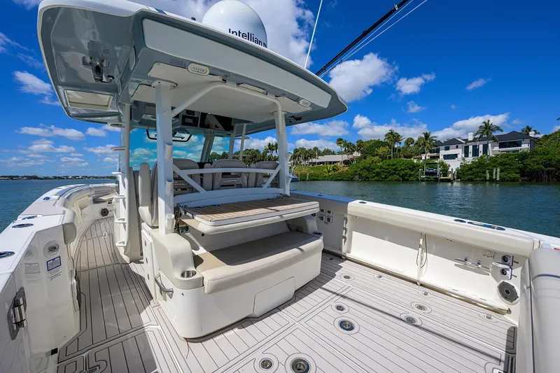 Who's Sippin Yacht Photos Pics Boston Whaler 380 Outrage 2021 boat deck with seating, under clear blue sky.