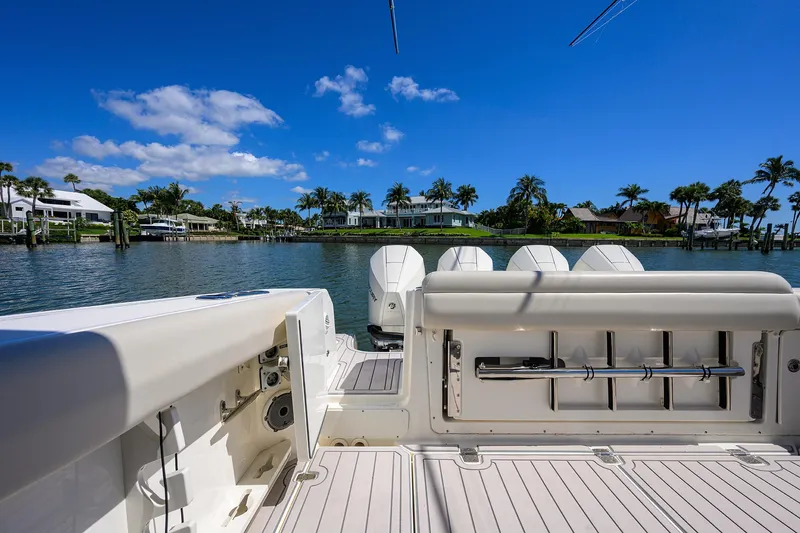 Who's Sippin Yacht Photos Pics Boston Whaler 380 Outrage 2021 boat with four engines, docked in a scenic waterfront location.
