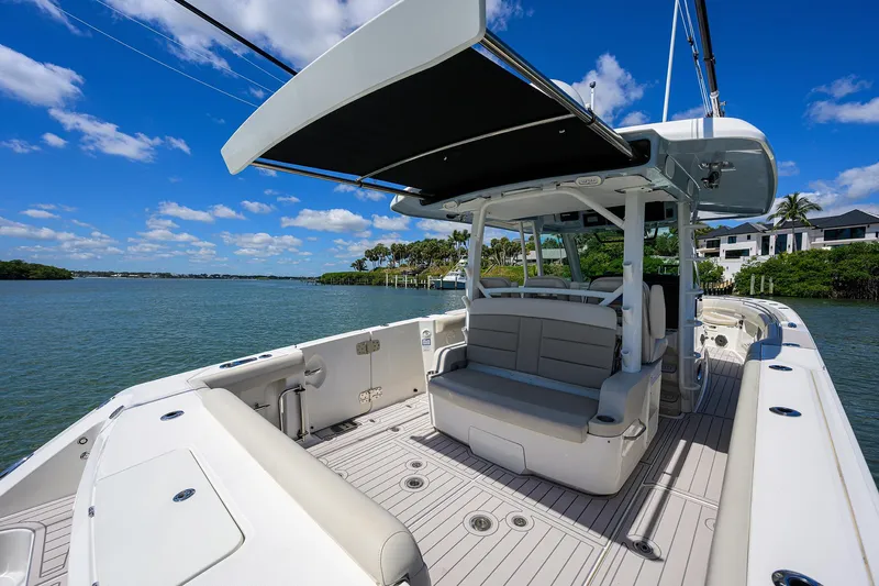 Who's Sippin Yacht Photos Pics 2021 Boston Whaler 380 Outrage boat with spacious deck and seating, under sunny skies.