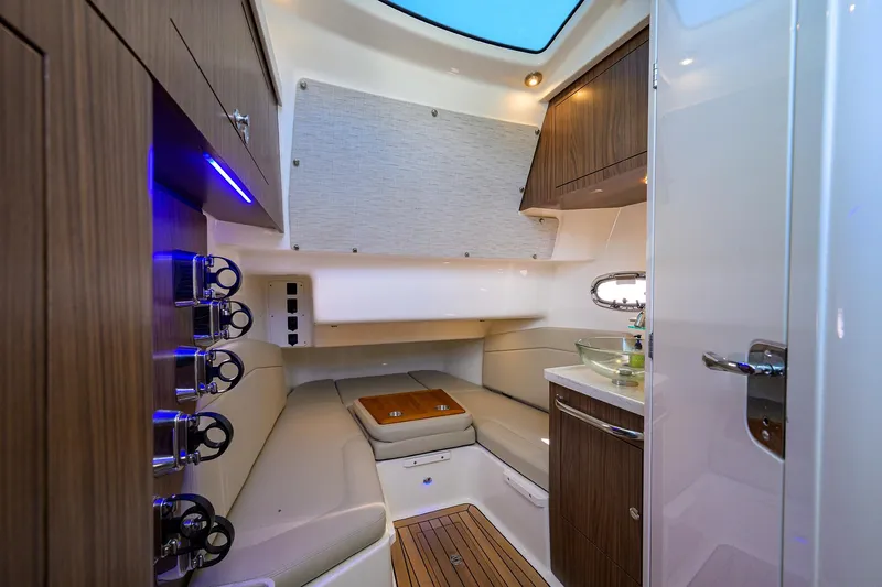 Who's Sippin Yacht Photos Pics Interior cabin of 2021 Boston Whaler 380 Outrage, featuring modern wood finishes and seating.