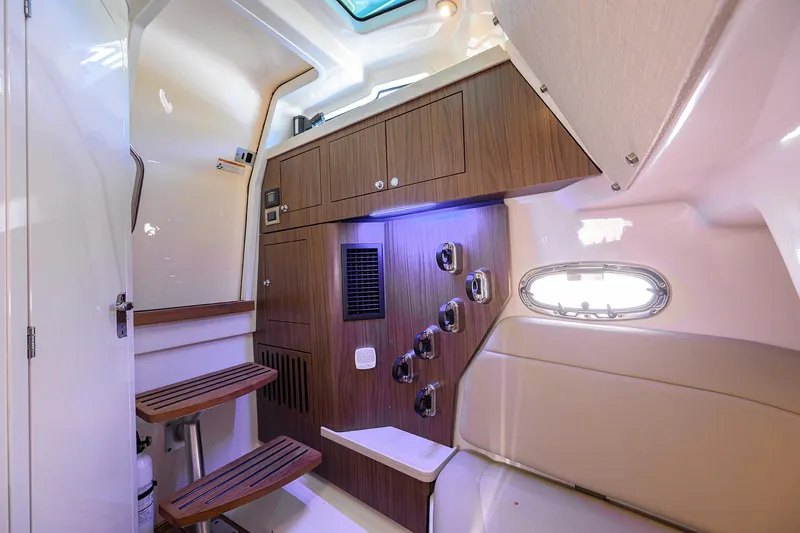 Who's Sippin Yacht Photos Pics Interior cabin of 2021 Boston Whaler 380 Outrage, featuring wood accents and seating.